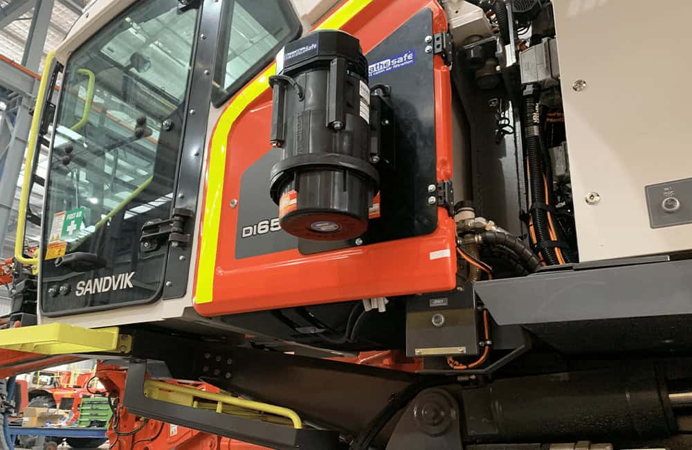 Sandvik construction machinery with BreatheSafe air filtration system in industrial setting, ensuring occupational health and safety, high-performance dust and fume filtration for heavy equipment operators, Australia.