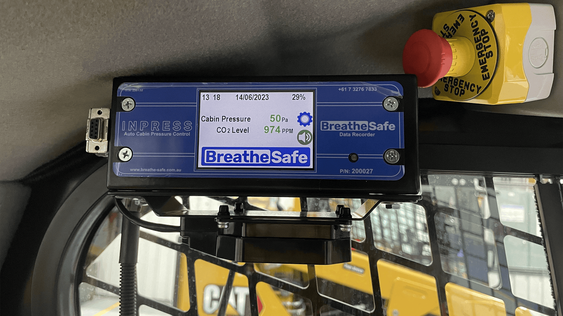 Emergency stop button with yellow and red colour scheme, safety control device for industrial or vehicle cabin safety systems.