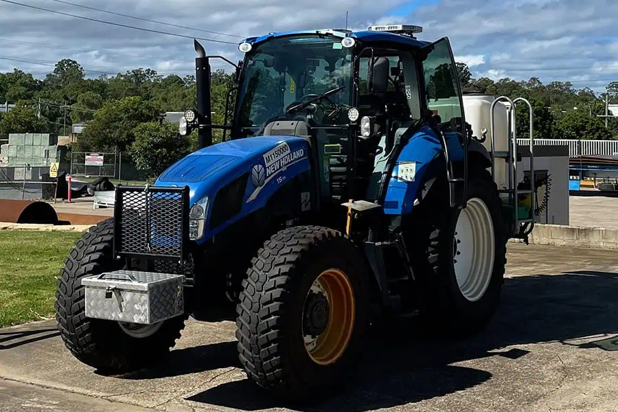 Brisbane sit-on mine dump truck at a construction site, large industrial heavy-duty machinery, used in excavation and mining operations, under clear blue sky.