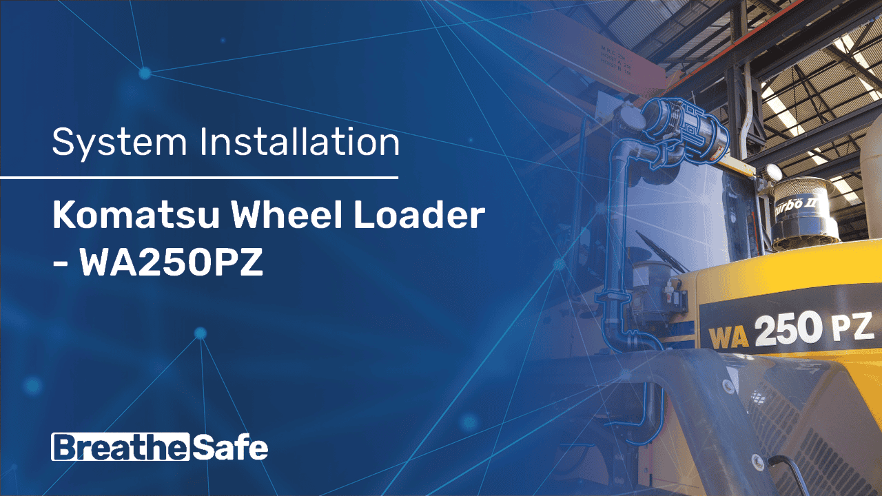 Image of a Komatsu WA250PZ wheel loader being installed in an industrial setting, showcasing heavy machinery used for material handling and construction projects.